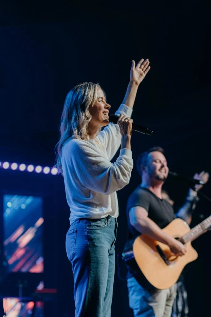 A worship leader sings at Current Church